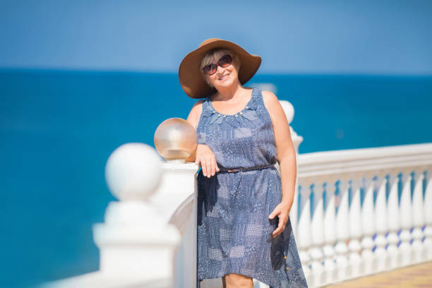 istock An elderly woman posing, sea at the background 1056390852