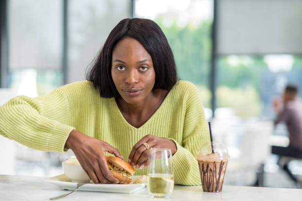istock Young black woman at lunch 1056392312