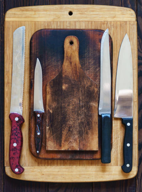 istock Wooden cutting boards and various kitchen knives 1056392378