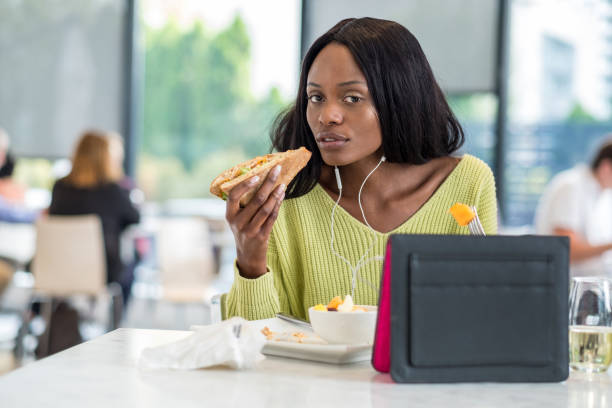 istock Young black woman at lunch 1056392394