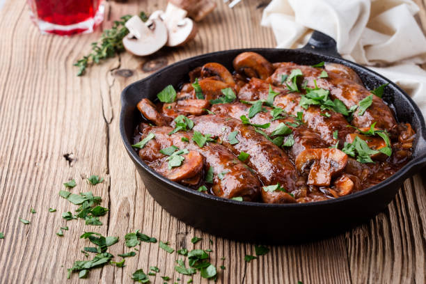 istock Sausages with onion and mushrooms gravy 1056392702