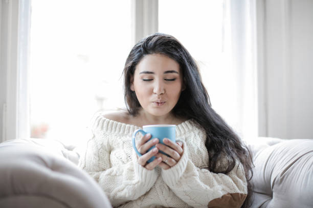 istock Girl blowing tea 1056393266