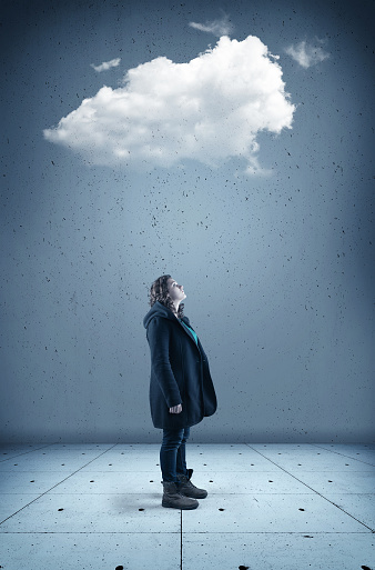 Young woman looks up to a cloud . The concept of cloud storage.