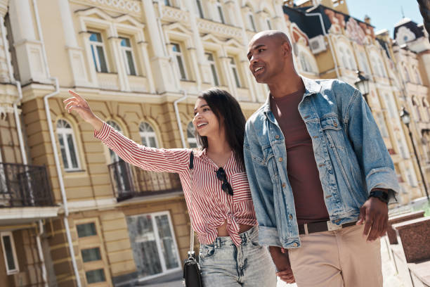 romantic relationship. young diverse couple walking on the city street holding hands sightseeing smiling happy - family african ethnicity black african descent imagens e fotografias de stock