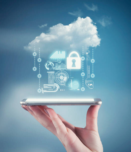 Hand holding a phone with a cloud and personal data information. The concept of personal data security stock photo
