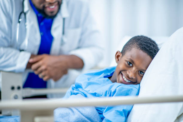 istock Cute boy smiling in his hospital bed 1056397668
