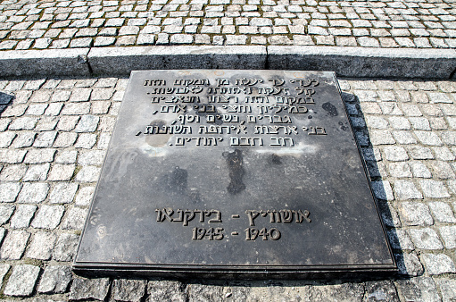 Yiddish commemorative plate at Birkenau concentration camp in Poland during summer day
