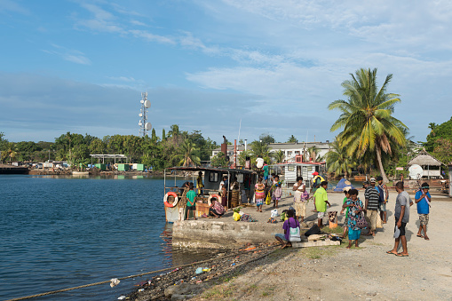 Passengers who traveled to Madang from Karkar Island disembark their small vessel, a copra boat, in Madang, Papua New Guinea. The journey on the Bismarck Sea took about five hours. (August 2017)