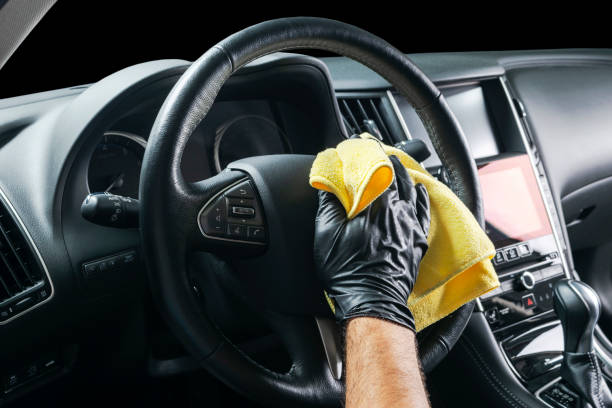 istock A man cleaning car with microfiber cloth. Car detailing. Valeting concept. Selective focus. Car detailing. Cleaning with sponge. Worker cleaning. Microfiber and cleaning solution to clean 1056403716