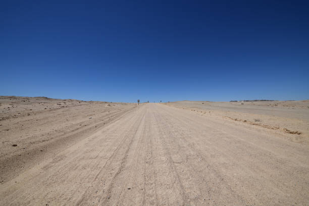 istock Dirt road with corrugations leading into distance. 1056404676