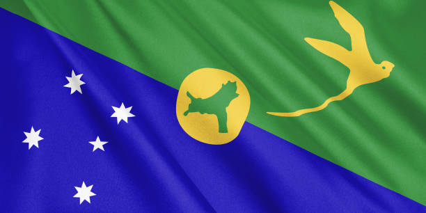 Small paper flag of curaçao on a white sandy beach with a crystal clear ocean.