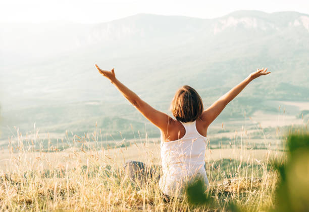 istock Woman meets sunrise in mountain 1056406988