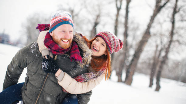 istock Young couple having fun in the snow 1056407816