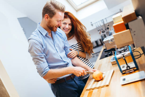 istock Couple making fresh organic juice 1056410142