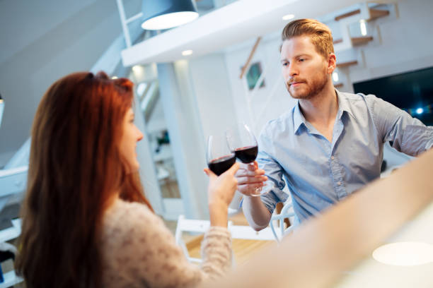 istock Beautiful couple toasting with wine 1056410448
