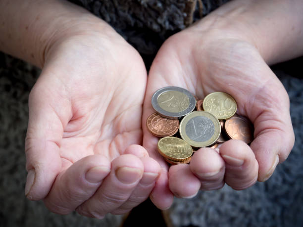 istock Retired with coins in hand. Problem of poverty. 1056415404