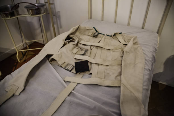 Old psychiatric straitjacket Old psychiatric straitjacket, mental hospital detail, psychosis restraining device stock pictures, royalty-free photos & images
