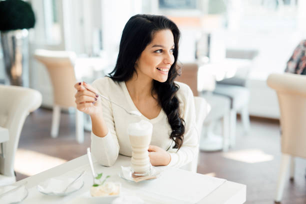 istock Glamorous lady drinking coffee in a beautiful cafe 1056416826