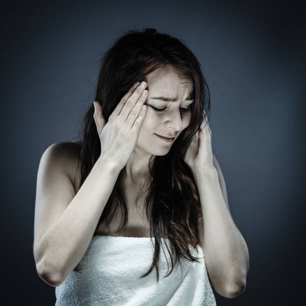 istock Woman massaging head pain 1056416984