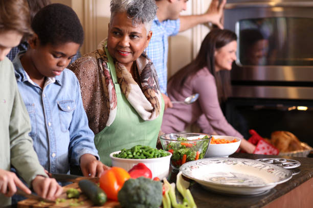 istock Diverse family in home kitchen cooking Thanksgiving dinner. 1056423244