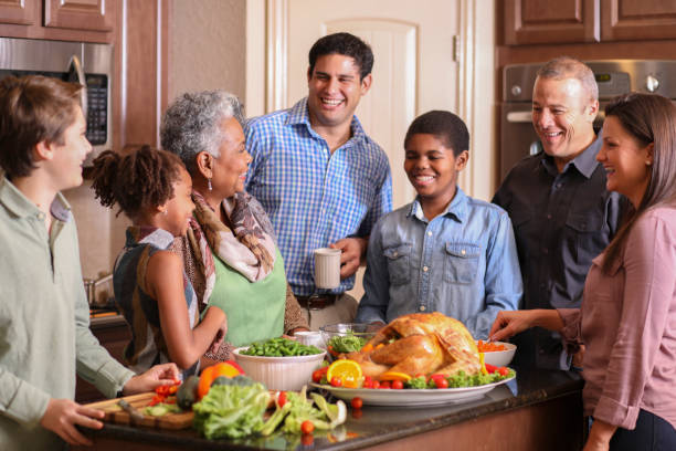 istock Diverse family in home kitchen cooking Thanksgiving dinner. 1056424468