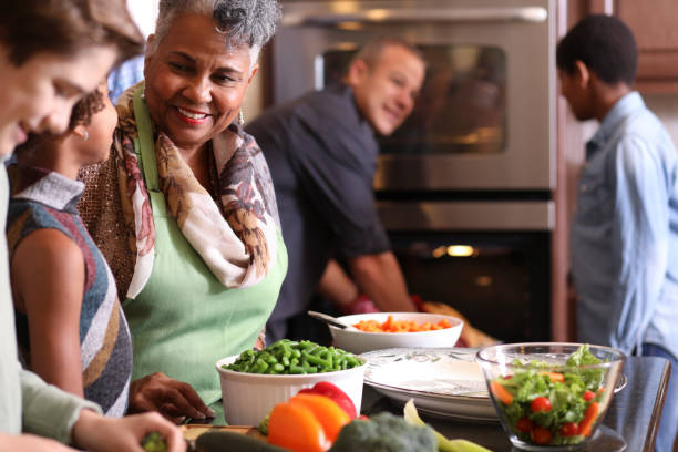 istock Diverse family in home kitchen cooking Thanksgiving dinner. 1056424568