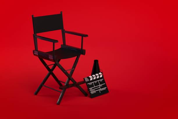 istock 3d Directors chair on film set on red background 1056430134