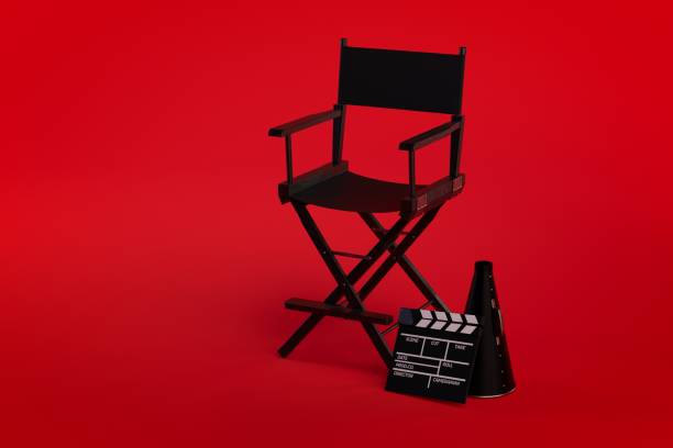 istock 3d Directors chair on film set on red background 1056430144