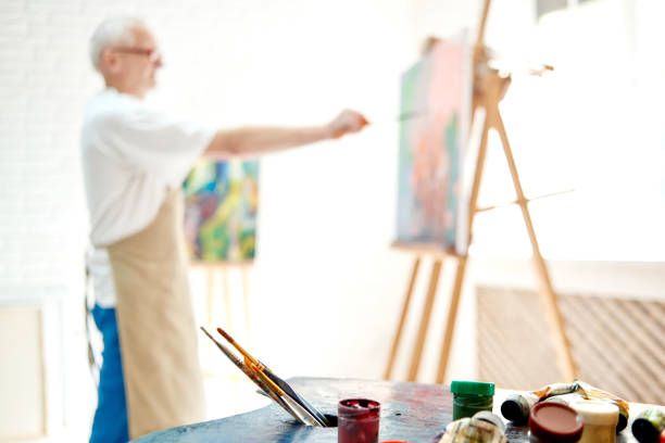 istock Selective focus on foreground with palette of paints and brushes. 1056430690