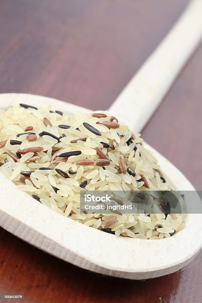 Mixed rice Close-up of various kinds of rice in a wooden spoon Black Color Stock Photo