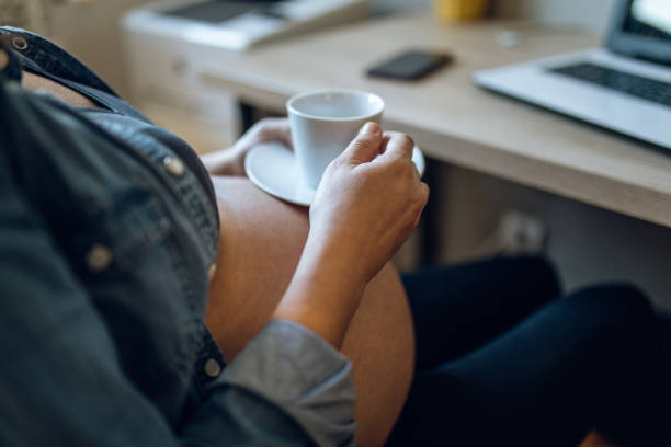 istock Pregnant woman taking a coffee break while working 1056436960