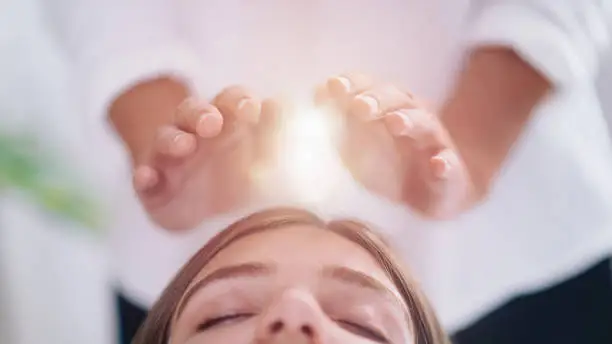 Photo of Close Up Of A Relaxed Young Woman Having Reiki Healing Treatment