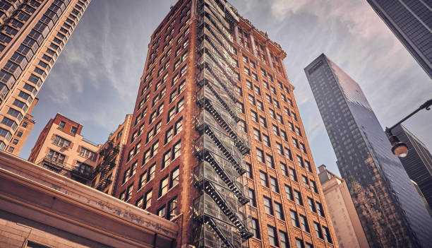 istock Looking up at old buildings in Manhattan, NYC. 1056443472