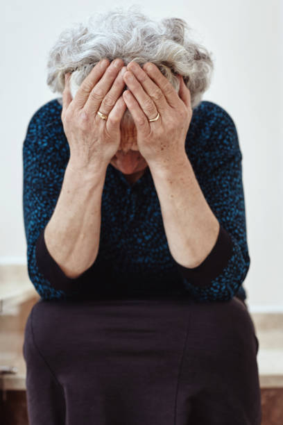 istock Old woman sitting on steps and crying 1056443694