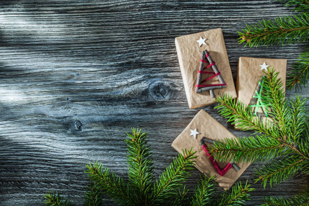 istock Green fir tree branches packed present box on wooden board 1056445584