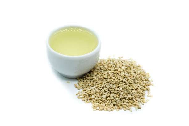 istock Sesame oil and sesame seeds isolated on white background 1056448738