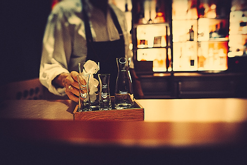 A bartender preparing a drink in a bar in berlin