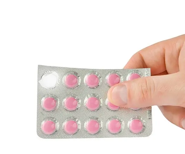 Photo of Holding contraceptive pills in hand