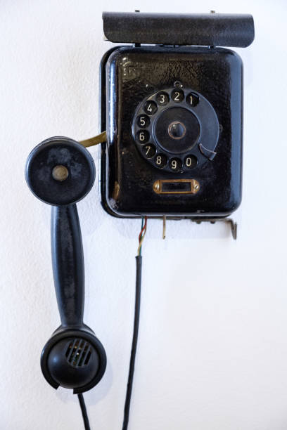 istock Classic old telephone on white dirty wall. vintage communication network. 1056452536
