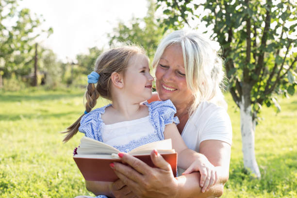 istock Grandmother and granddaughter reading book 1056452842
