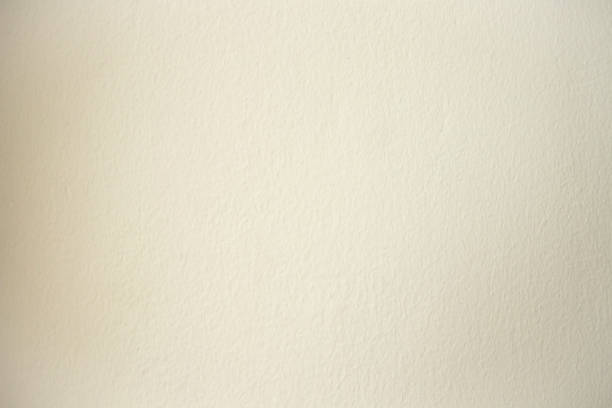 istock cream cement wall for background, wallpaper,template and copy space.cream color wall background. 1056460328