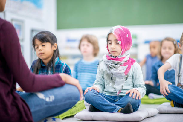 istock Preschool children meditating cross-legged 1056460458