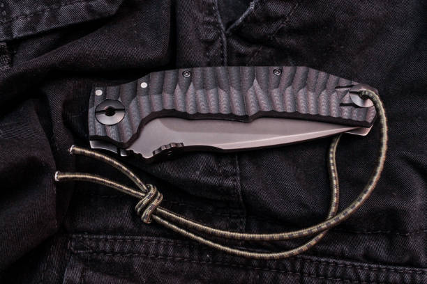 istock Folding knife knife on a black background. 1056461716