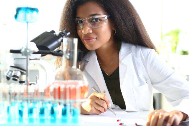 istock Black woman scientist student chemist in protective 1056468370