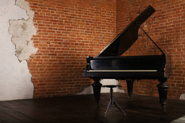 レンガの壁の近くの上げられたふた付けグランド ピアノ - musical theater music antique musical note ストックフォトと画像