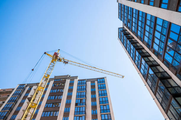istock Construction of a high-rise building with a crane. Building construction using formwork. Cranes and buildings against the blue sky. 1056469910
