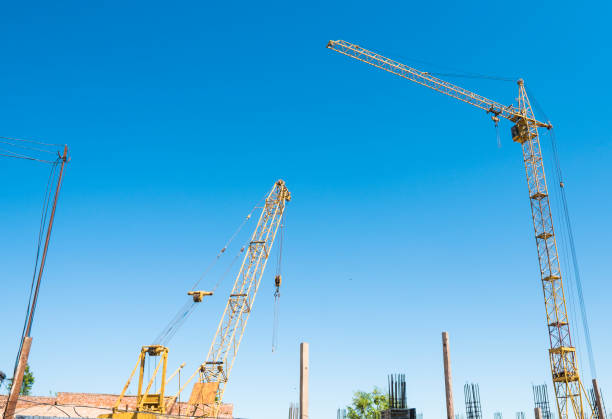 istock Construction of a high-rise building with a crane. Building construction using formwork. Cranes and buildings against the blue sky. 1056470030