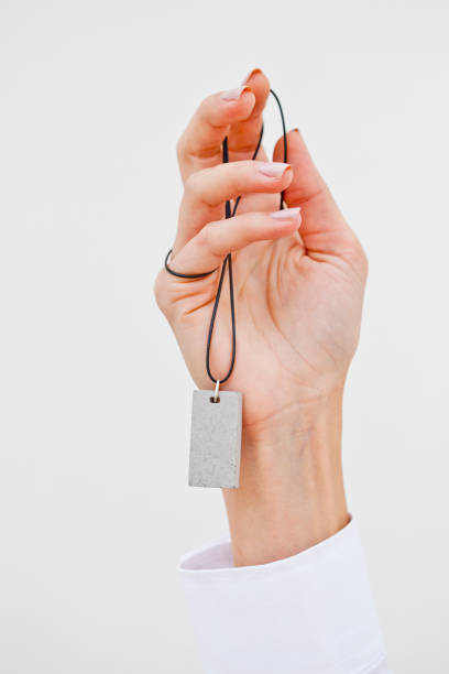 istock Hand holding stylish necklace. 1056470070
