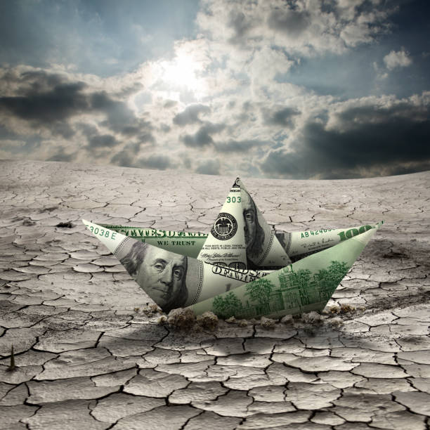 Conceptual one hundred dollar paper boat on dried landscape over cloudy sky Conceptual image of one hundred dollar paper boat on cracked and dried landscape over cloudy sky making money origami stock pictures, royalty-free photos & images