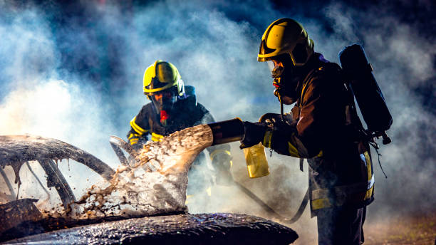 istock Firefighters extinguishing a car fire with foamy water 1056471690